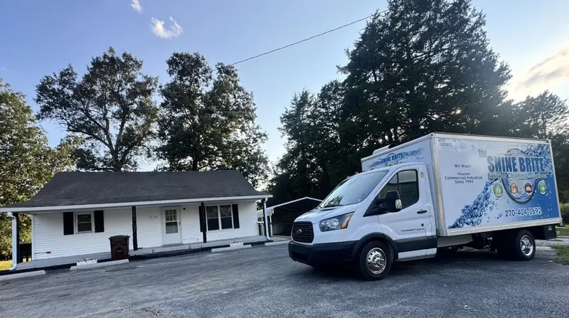 Transit box truck at a small home